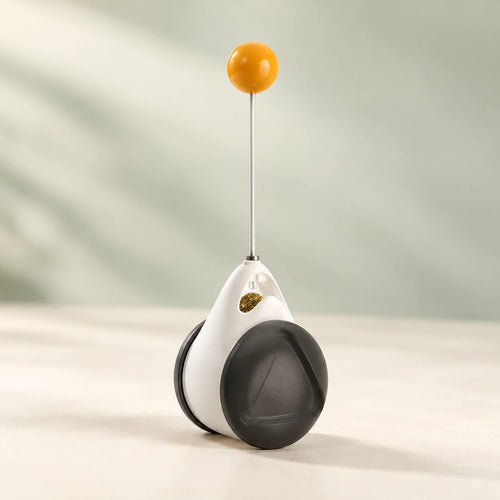 PawPivot black-and-white balance toy with a slender stem and yellow top ball.