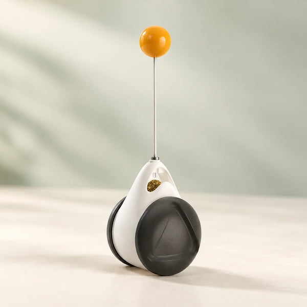 PawPivot black-and-white balance toy with a slender stem and yellow top ball.