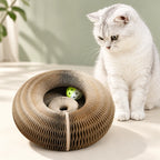 White cat beside the CurlNest accordion paper scratcher.