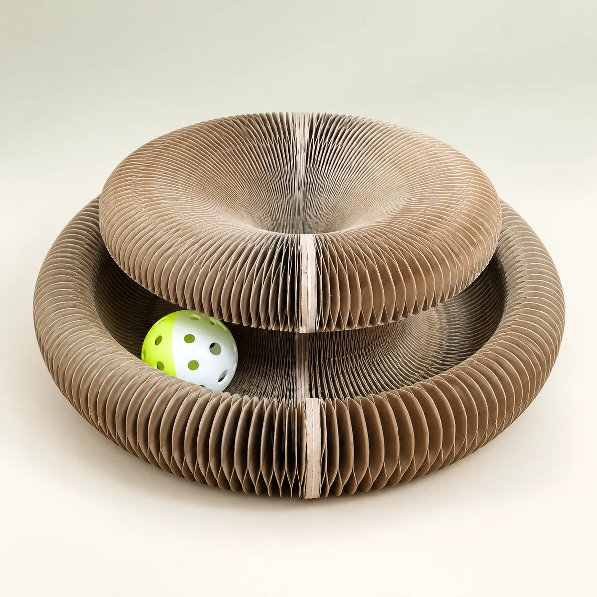CurlNest scratching board in its alternate double-ring fold with one play ball.