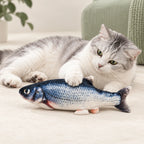 Silver-and-white cat touching a FinFlip Blue Fish plush toy.
